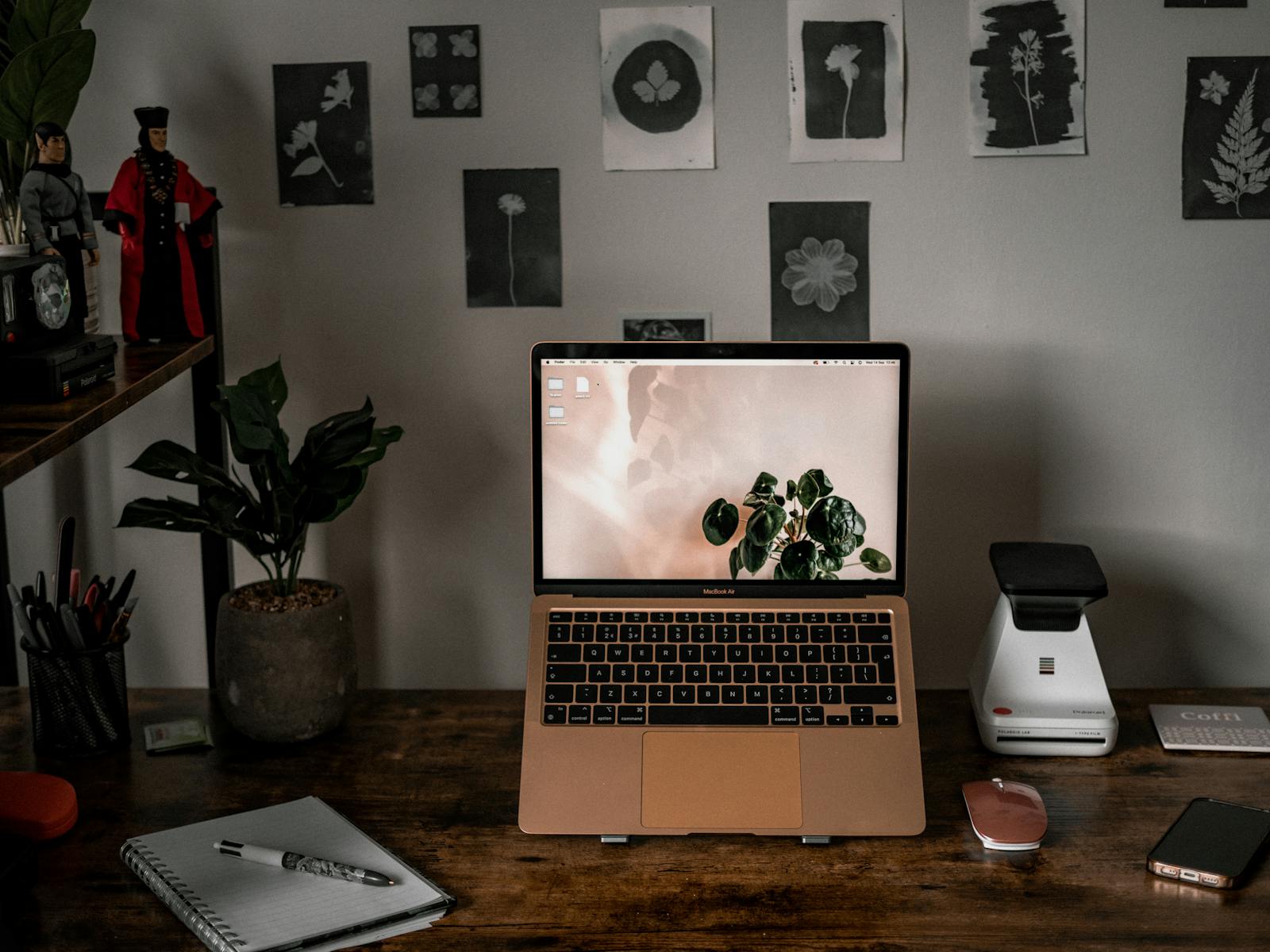 Creative craft business owner using a laptop inside a workshop studio.