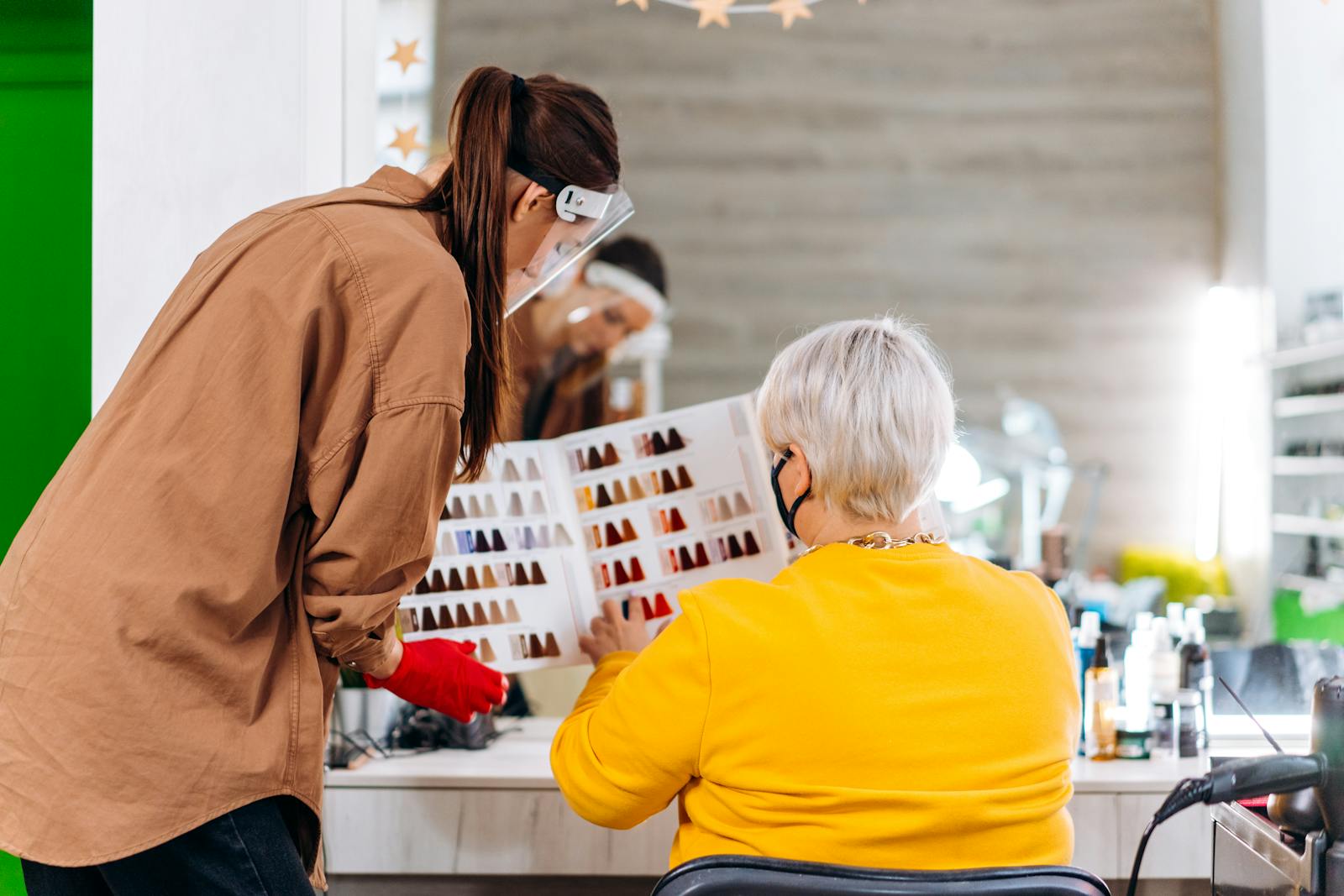 Hairstylist consulting with a client in a salon.